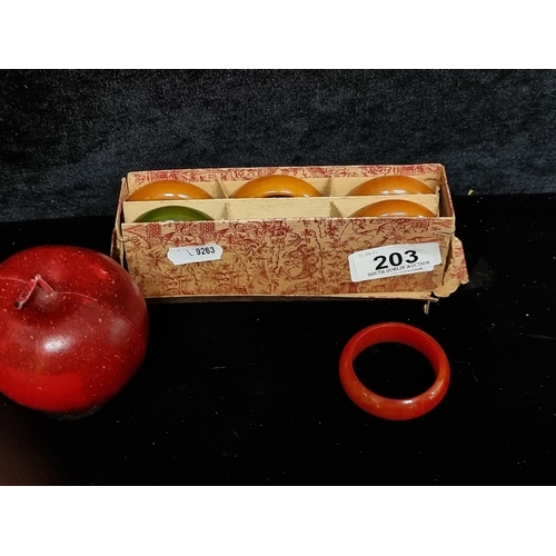 203 - A vintage set of six colourful bakelite napkin rings in original presentation box.