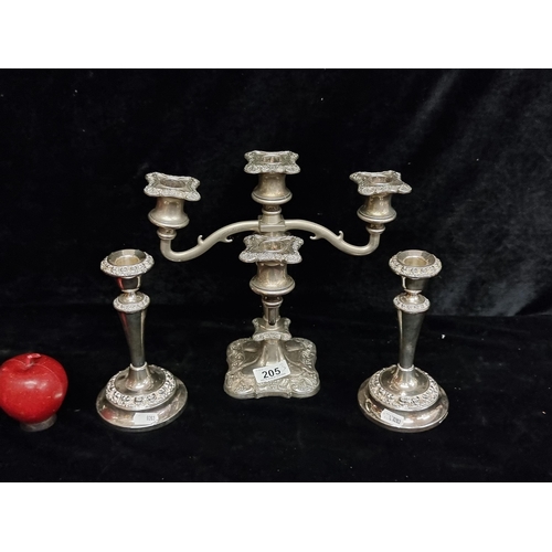 205 - Three vintage silver plated candle holders including a five-branch candelabra.