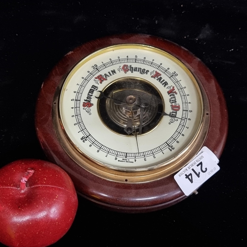 214 - A nice vintage West German barometer with an enamel dial and housed in a wooden case.