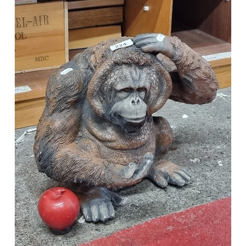 224 - A very heavy reconstituted stone garden figure of an orangutan. Features great detail. H32cm