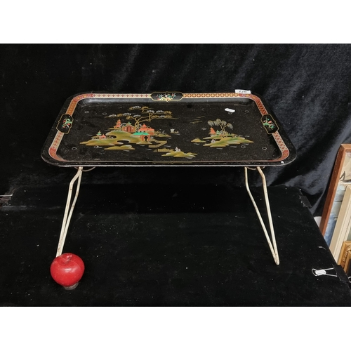 228 - A vintage black mid century metal folding breakfast / butlers tray. Features painted chinoiserie tra... 