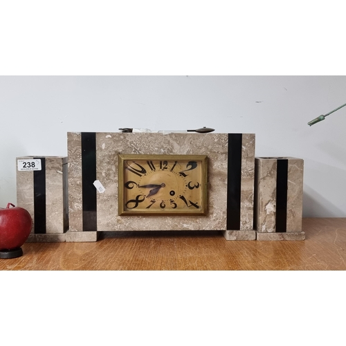 238 - Star Lot : A heavy French made Art Deco clock in marble with two garnitures and abstract numerals to... 