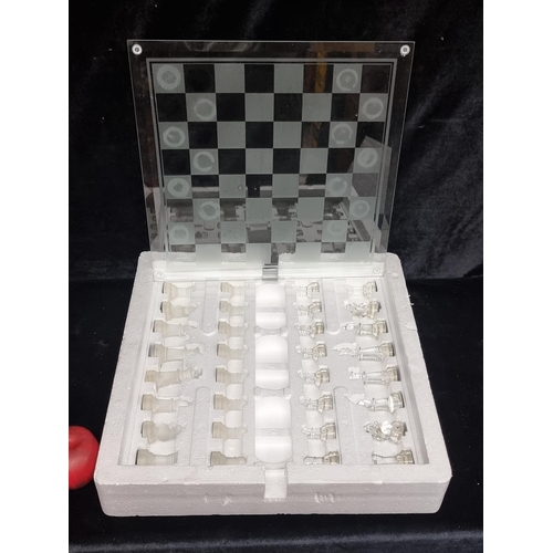 262 - A complete chess set comprising of a glass board and glass pieces in a glossy and matte finish. With... 