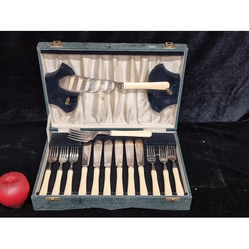 263 - A complete vintage canteen containing fourteen silver plated pieces of silverware including forks, k... 