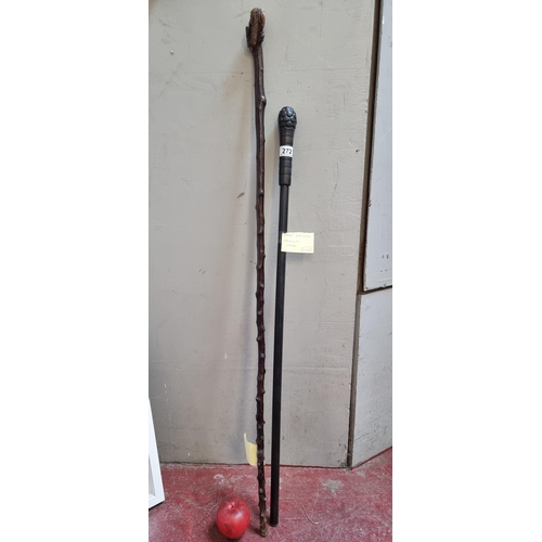 272 - A vintage ebonised walking stick along with a blackthorn example.