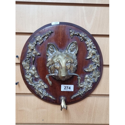 274 - A vintage wall plaque holding a fine brass fox head with beautiful foliate border. Mounted on a wood... 