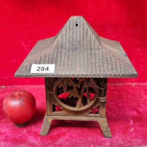 284 - An unusual very heavy vintage cast iron Japanese Pagoda formed candle holder, featuring pierced bamb... 