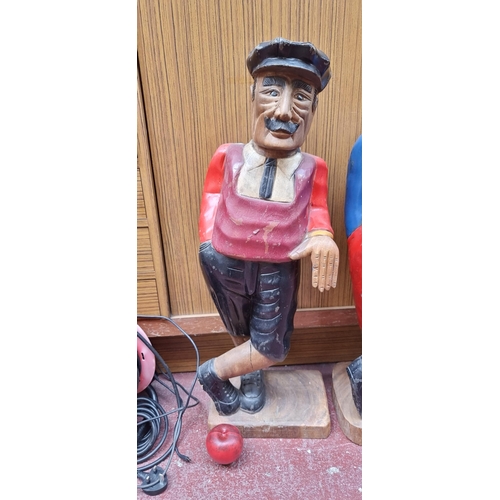 293 - A tall hand carved heavy free standing golfer statue, featuring characterful features, heavy thick w... 