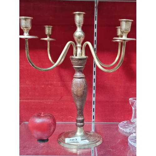 303 - An unusual table top four branch candelabra, featuring brushed brass stems, base and drip cups and a... 