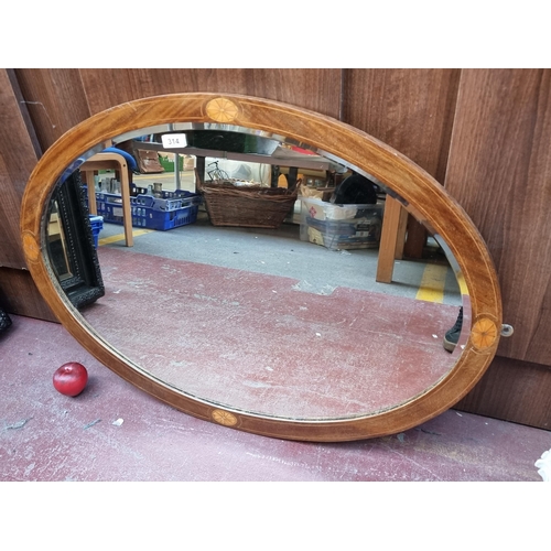 314 - An elegant example of an Edwardian  large oval wall hanging walnut mirror, featuring nicely inlayed ... 