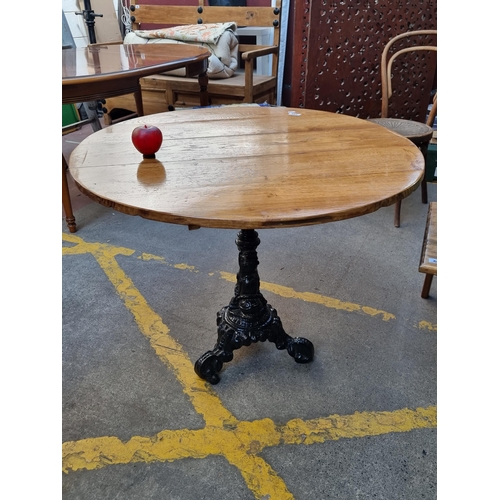 344 - Star Lot : A beautifully antique hand crafted round table with a very heavy cast iron base.