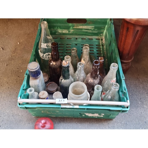 373 - A crate containing approx. 23 vintage glass bottles including Coca-cola and Pepsi examples