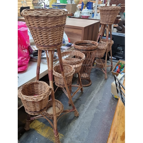 392 - Four brand new wicker items  including two tiered plant stands, another individual plant stand and u... 