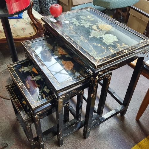 394 - Star Lot - A set of four high quality lacquered nesting tables with carved floral appliqués and temp... 