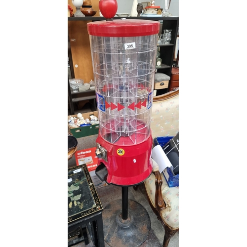 395 - A coin operated confectionary machine with a coin slot, multiple compartments and a weighted base. H... 