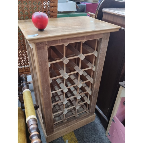 426 - A wonderful 18 bottle wooden wine rack. H82cm x W48cm x D33cm.