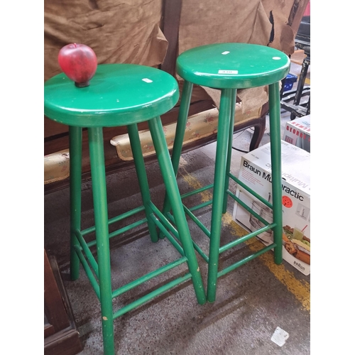 430 - A handy pair of breakfast bar stools in a vibrant green colour.