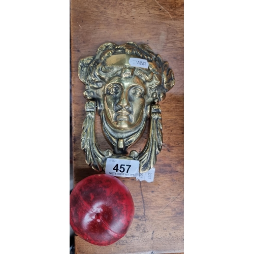 457 - A large heavy brass door knocker featuring a Neoclassical female head.