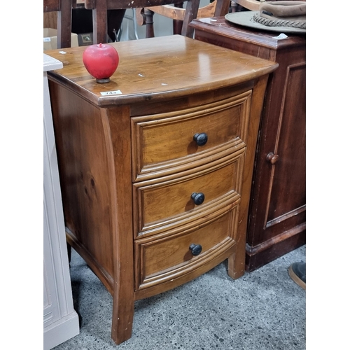 743 - A well made wooden bedside cabinet with three drawers. Features bow front and metal pull handles.
H ... 