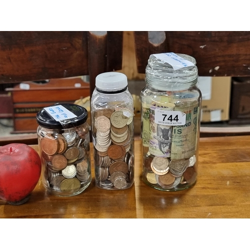 744 - Three containers of unchecked coins and notes. Including pre Euro Irish coins, English Sterling coin... 