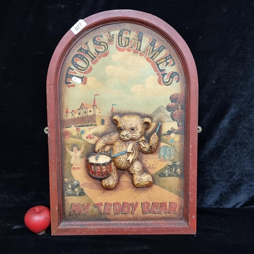 77 - A vintage wooden relief panel advertising Toys and Games featuring a marching teddy bear playing his... 