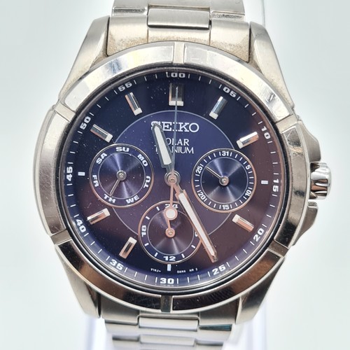 5 - A fine example of a sleek Seiko solar titanium gentleman's wrist watch, featuring a sporty blue face... 