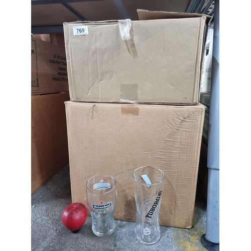 769 - Two boxes of brand new pint pub glasses, including two boxes of Heineken glasses along with a box of... 