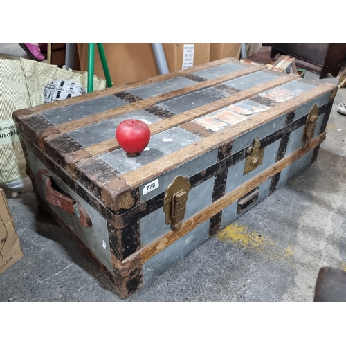 778 - A fantastic early 20th Century travel trunk with leather handles to either side and brass hardware f... 