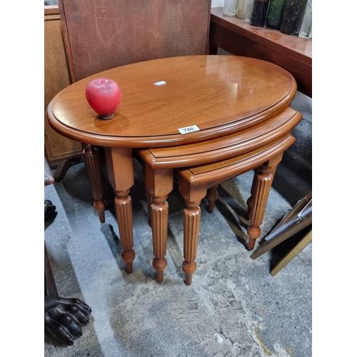 780 - A gorgeous set of high quality nesting tables with fluted legs.