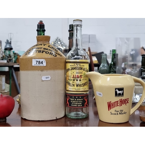 784 - A trio of pub memorabilia including a White Horse whisky jug by Seton pottery and a stoneware flagon... 