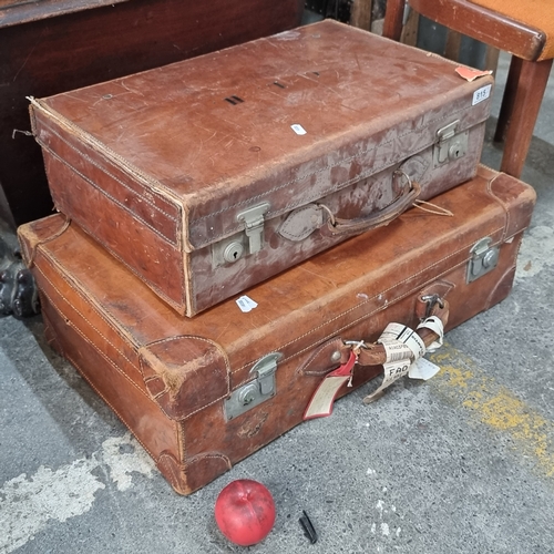 815 - A pair of leather bound suitcases including one embossed with the initials C. L. H. along with a lar... 