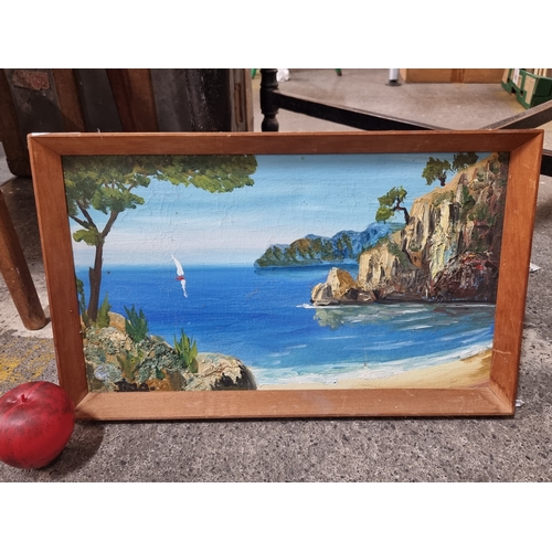 825 - An original vintage oil on canvas painting featuring thick impasto paint to the coastal rocks. House... 