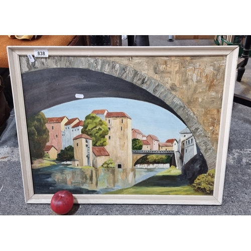 838 - An original vintage oil on board painting of the city of Mostar. Unsigned and housed in a cream fram... 