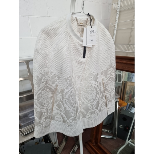 888 - A beautiful brand new with tags ladies Ted Baker embroidered cape in an cream tone. Size medium. Int... 