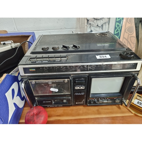 894 - A vintage Hitachi trimode portable combination including colour television, cassette recorder and ra... 