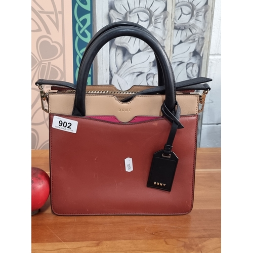 902 - A stylish genuine leather DKNY ladies handbag, with three internal storage pockets and in excellent ... 