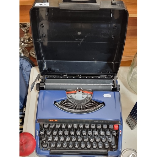 904 - A smart Brother Deluxe 240T typewriter housed in a hard shell travel case.