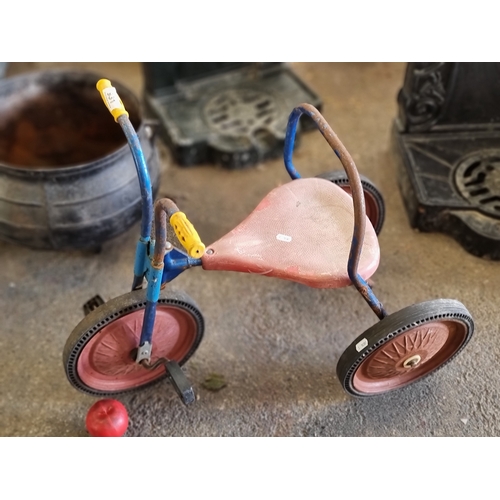 931 - A vintage children's tricycle with three metal and rubber wheels, backrest, pedals and handles.