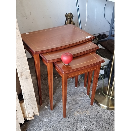 933 - A handsome three piece nesting table with attractive string inlay.