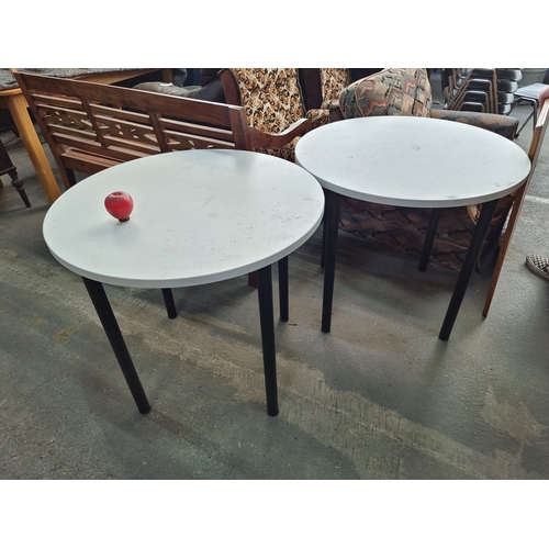 953 - A pair of café dining tables with round tops held on black metal legs. H73cm x D80cm No reserve €1 s... 