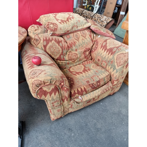 974 - A fabulous, very comfortable armchair with deep seat and matching cushion. Finished in a heavy woven... 