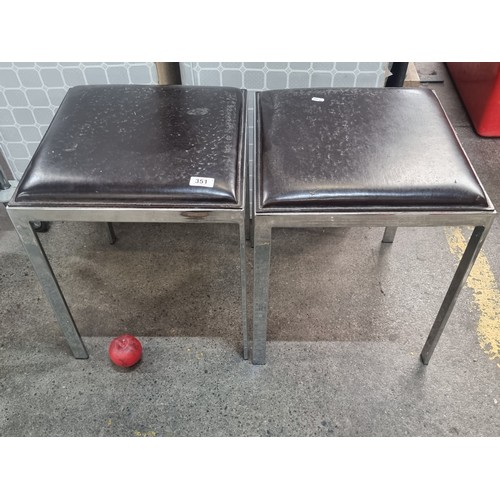 351 - A pair of chic square footstools upholstered in a brown leather fabric. Held on stylish chrome legs.