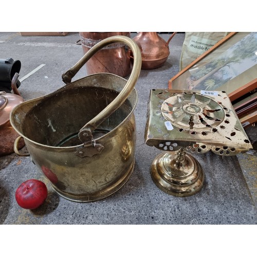 889 - Two brass items including a vintage coal scuttle with a handle and a pierced ecclesastical trivet  f... 