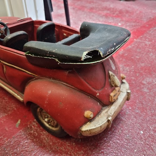 128 - A large model convertible car with rotating wheels. Slight Damage to back. L66cm x H28cm