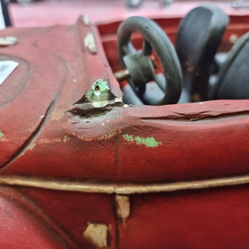 128 - A large model convertible car with rotating wheels. Slight Damage to back. L66cm x H28cm