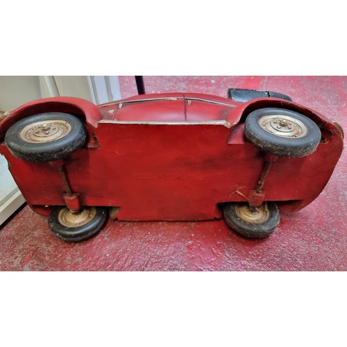 128 - A large model convertible car with rotating wheels. Slight Damage to back. L66cm x H28cm