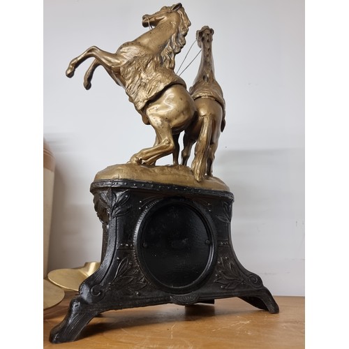 192 - Star Lot : An ornate vintage German made mantle clock topped with a man leading two horses in gilded... 