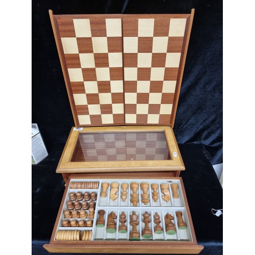 261 - An elegant complete chess and checkers set comprising of a wooden box with a glass panel, a shelf ho... 