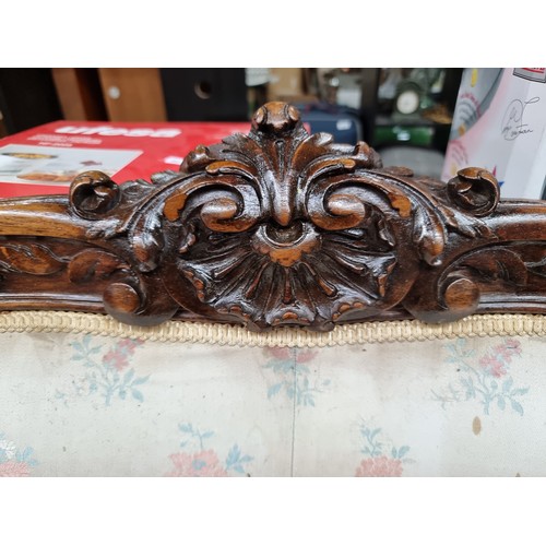 396 - Star Lot : A horse hair original Victorian three-seater sofa with intricate carved wooden detailing,... 