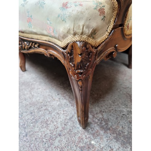 396 - Star Lot : A horse hair original Victorian three-seater sofa with intricate carved wooden detailing,... 